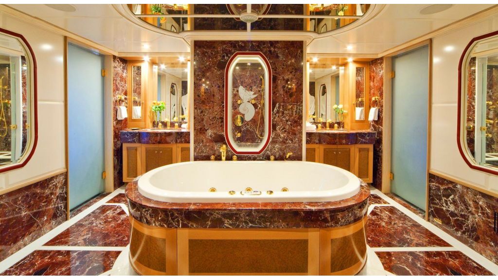 Luxury 50m Aluminum Yacht, The 43" flat screen TV can be viewed from the king sized bed or angled towards the curved sofa to starboard